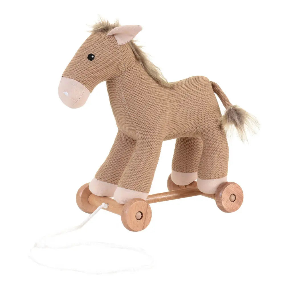 Knitted horse pull toy with wooden wheels on a white background