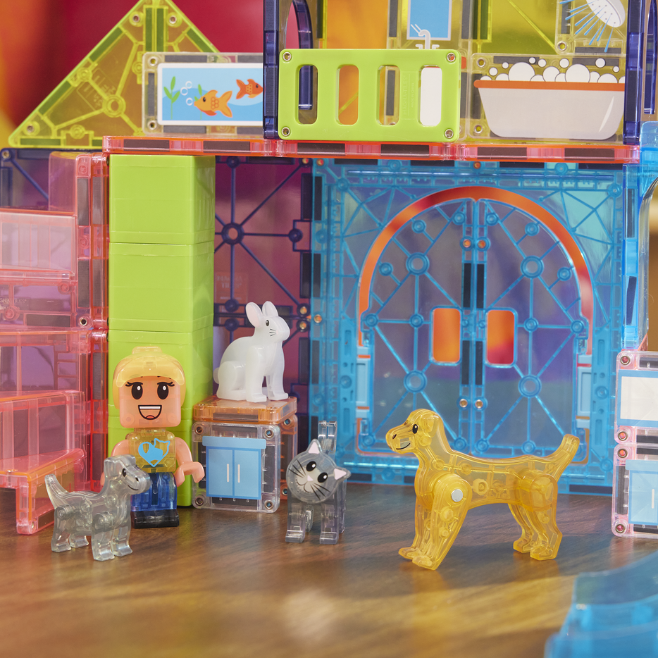 Toy set with transparent blocks, figures, and animals on a wooden surface