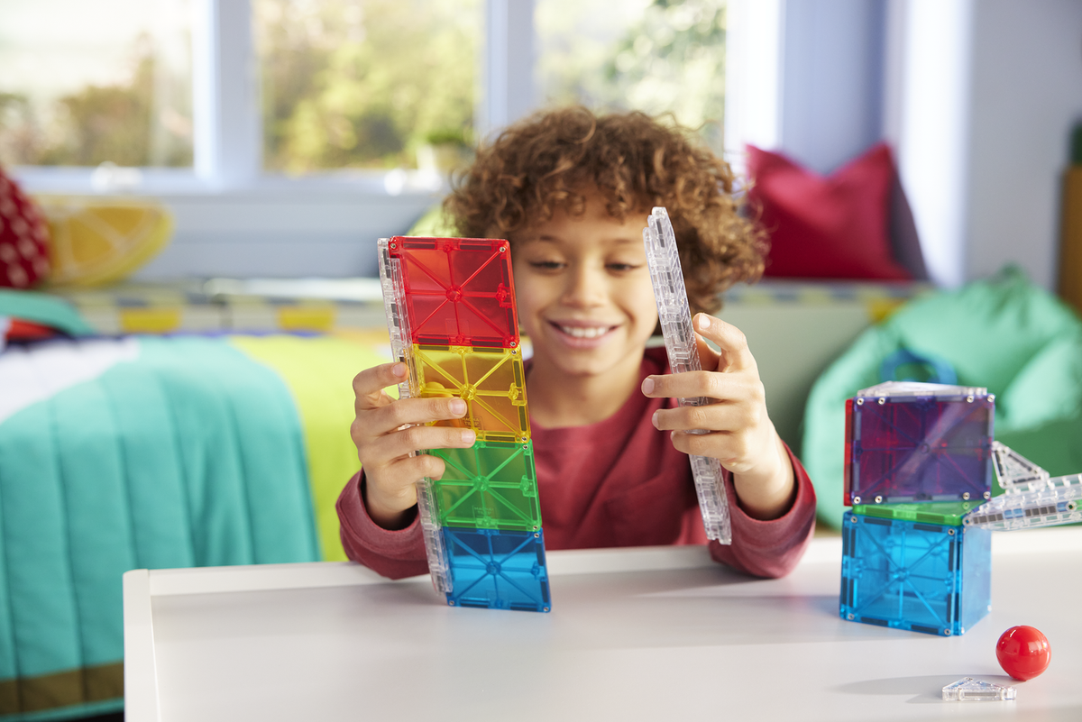 Child playing with colorful building blocks in a bright room