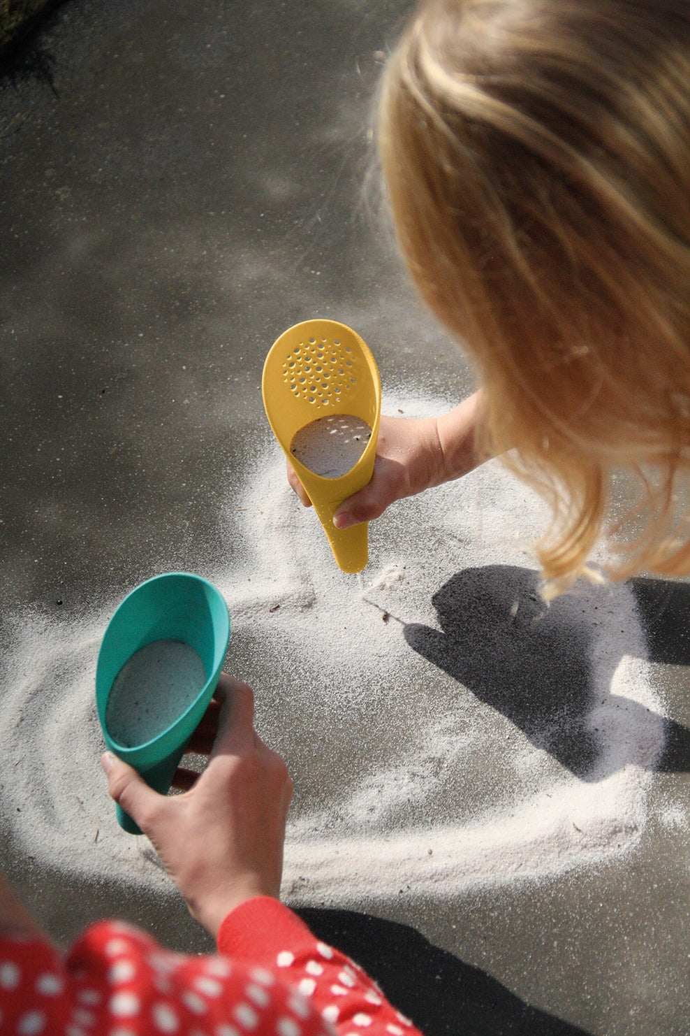 Child playing with sand toys in a sandbox