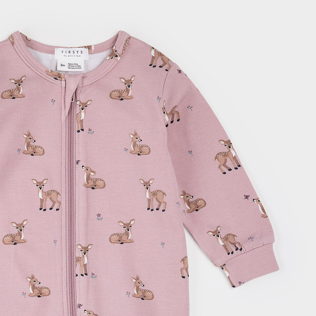 A pink long-sleeve baby zip-up romper with an all-over print of brown fawns and small blue flowers, shown on a light gray background.