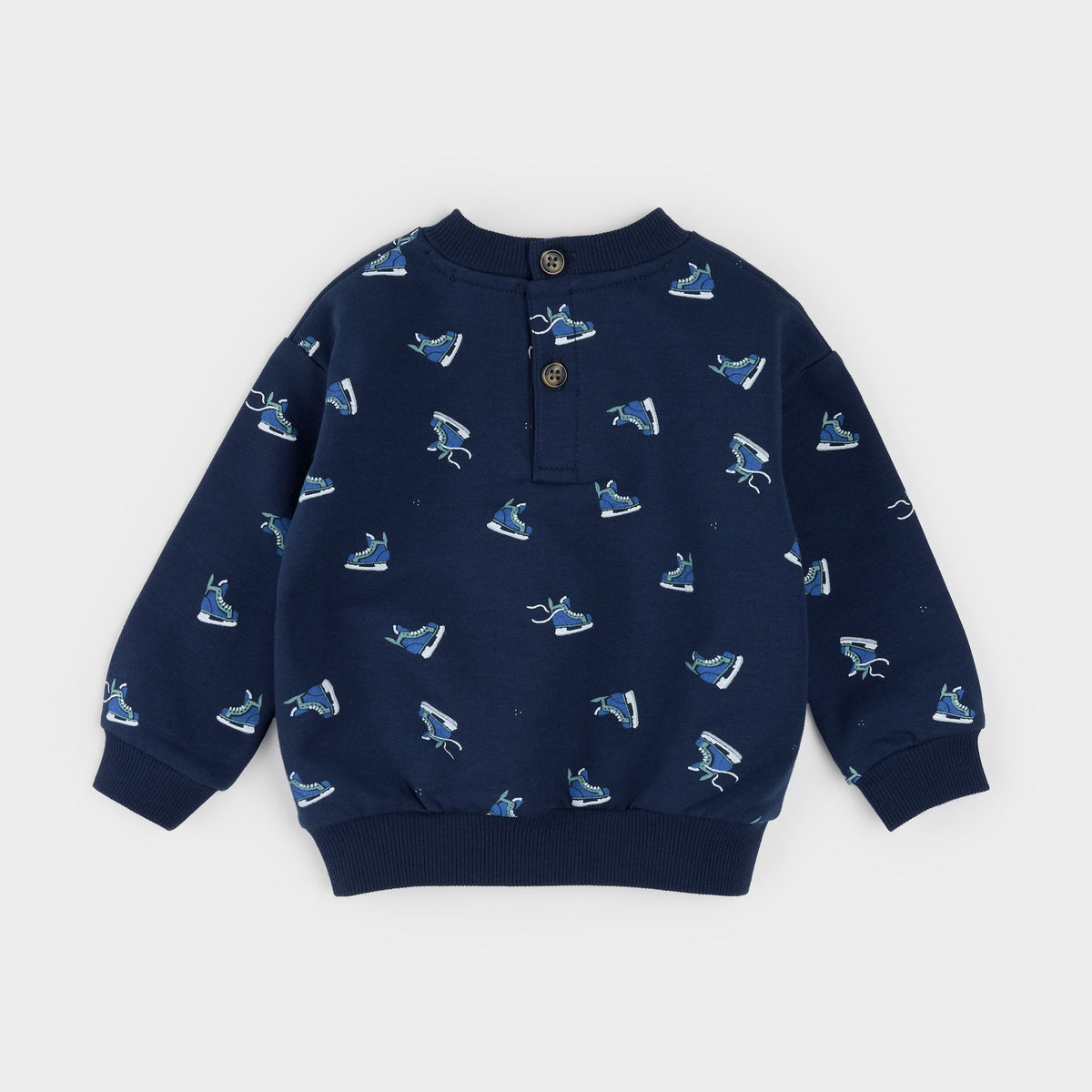 A navy blue long-sleeve children's henley sweatshirt with an all-over ice skate print, featuring a three-button placket and ribbed collar, cuffs, and hem, shown flat on a light gray background.
