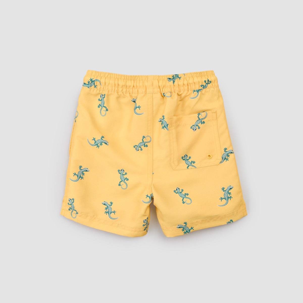 Yellow shorts with green lizard pattern on a light gray background