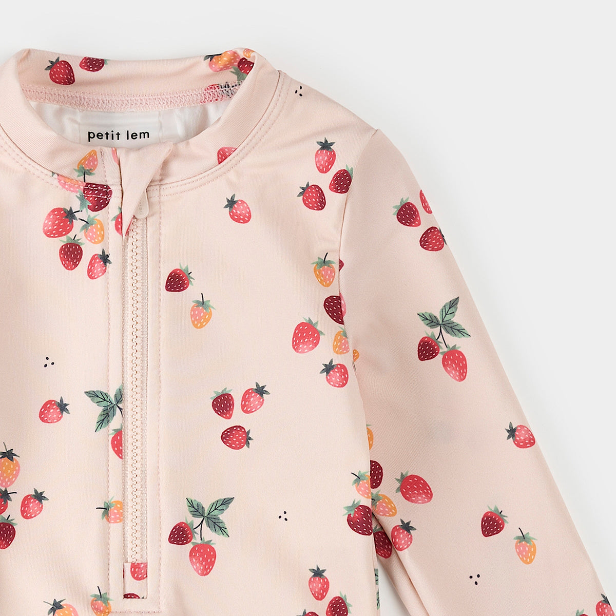 Baby onesie with strawberry pattern and 'petit lem' branding on a white background