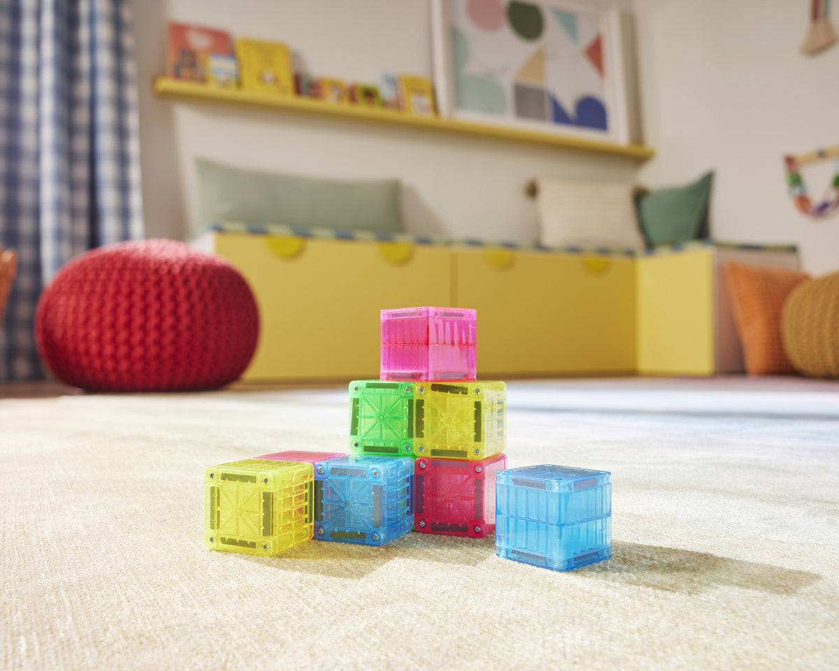 Colorful building blocks on a carpeted floor with a child's room in the background