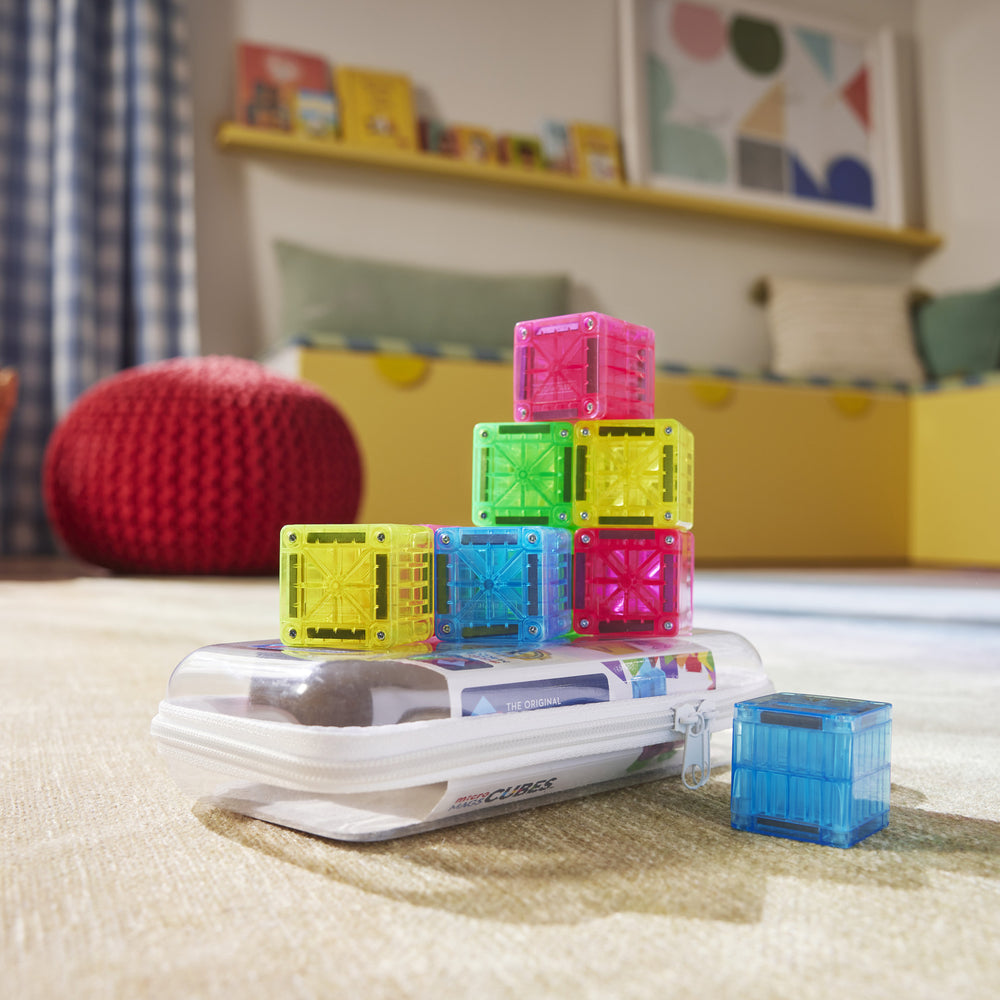 Colorful building blocks on a white surface with a child's room in the background