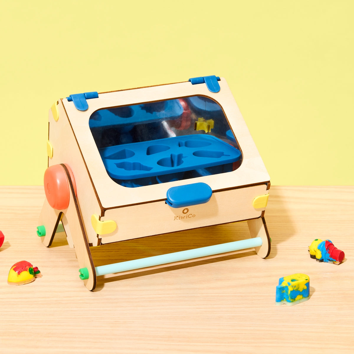 Children's toy with colorful components on a wooden surface and yellow background