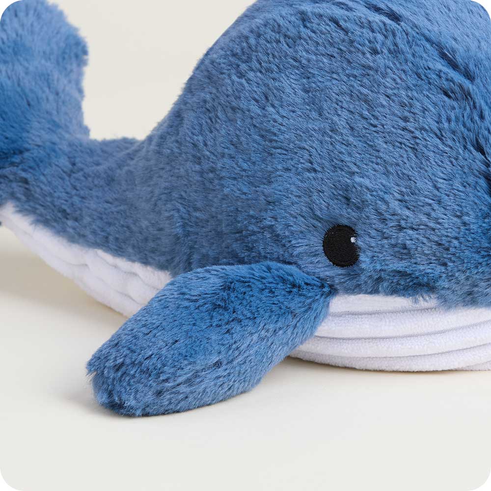 Blue plush whale toy on a light background