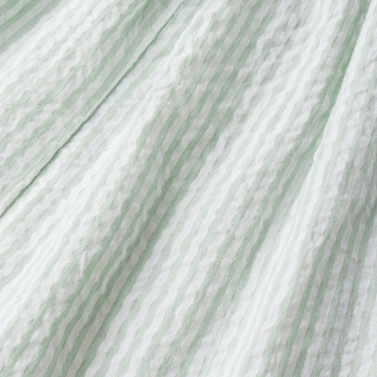 Close-up of green and white striped fabric texture