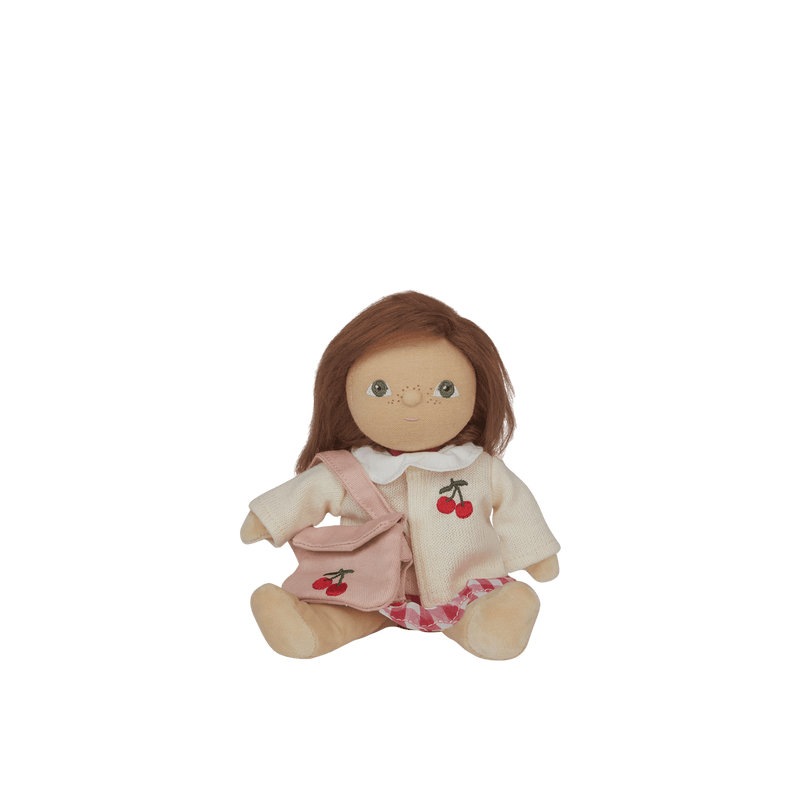 Stuffed doll with brown hair and a pink outfit on a transparent background