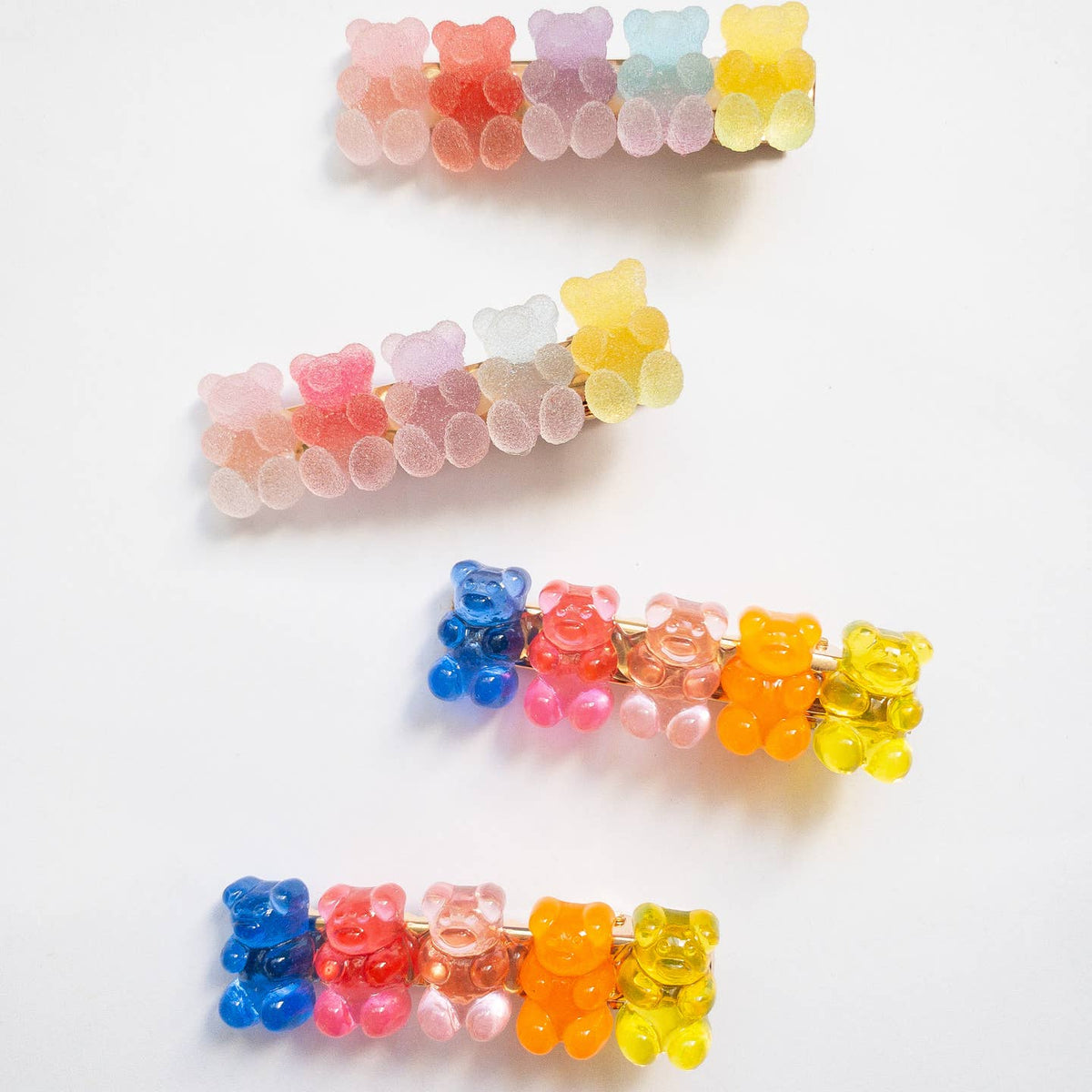 Colorful gummy bear-shaped hair clips on a white background