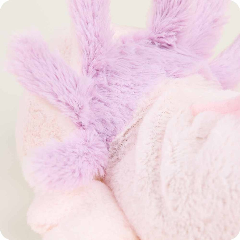 A close-up side view of the Pink Axolotl by Warmies plush toy, focusing on its fluffy purple external gills and soft light pink head.