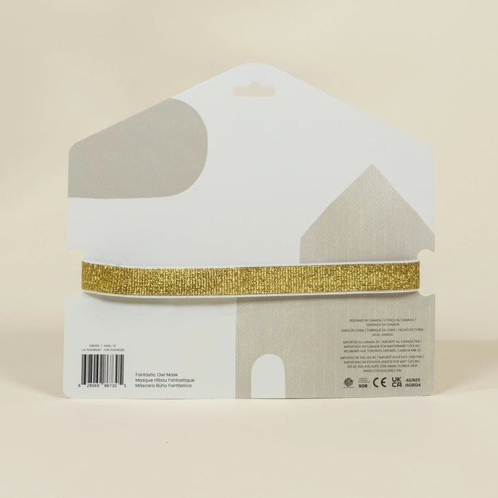 A house-shaped white display card holding a single strip of glittery gold ribbon, photographed against a plain warm beige background.