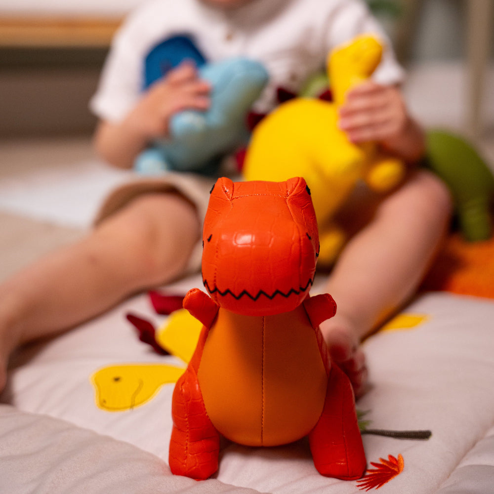 Child playing with colorful stuffed animals on a bed
