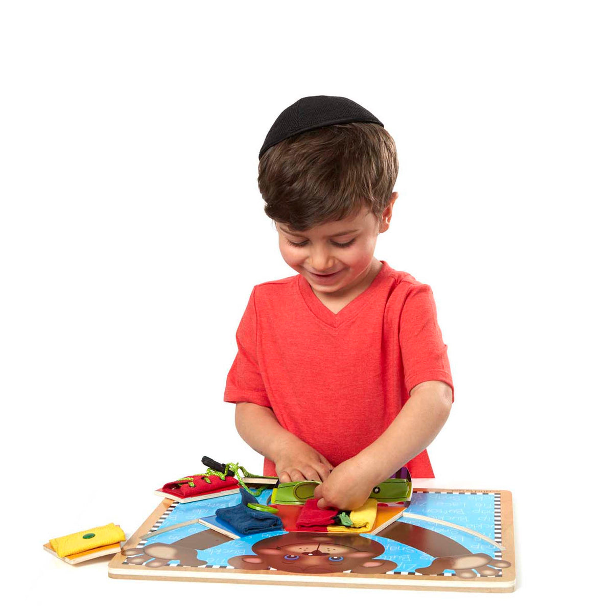 Child with glasses playing with a puzzle at a table