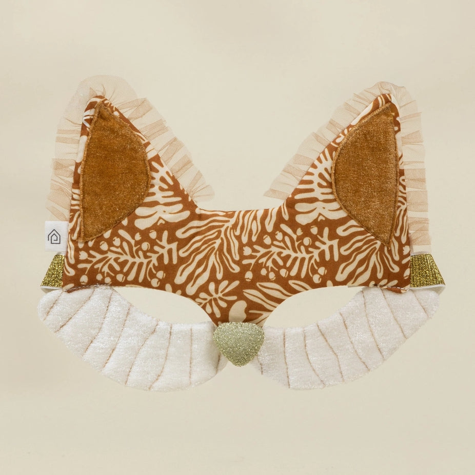 Fabric bow with brown pattern and white ruffles on a beige background
