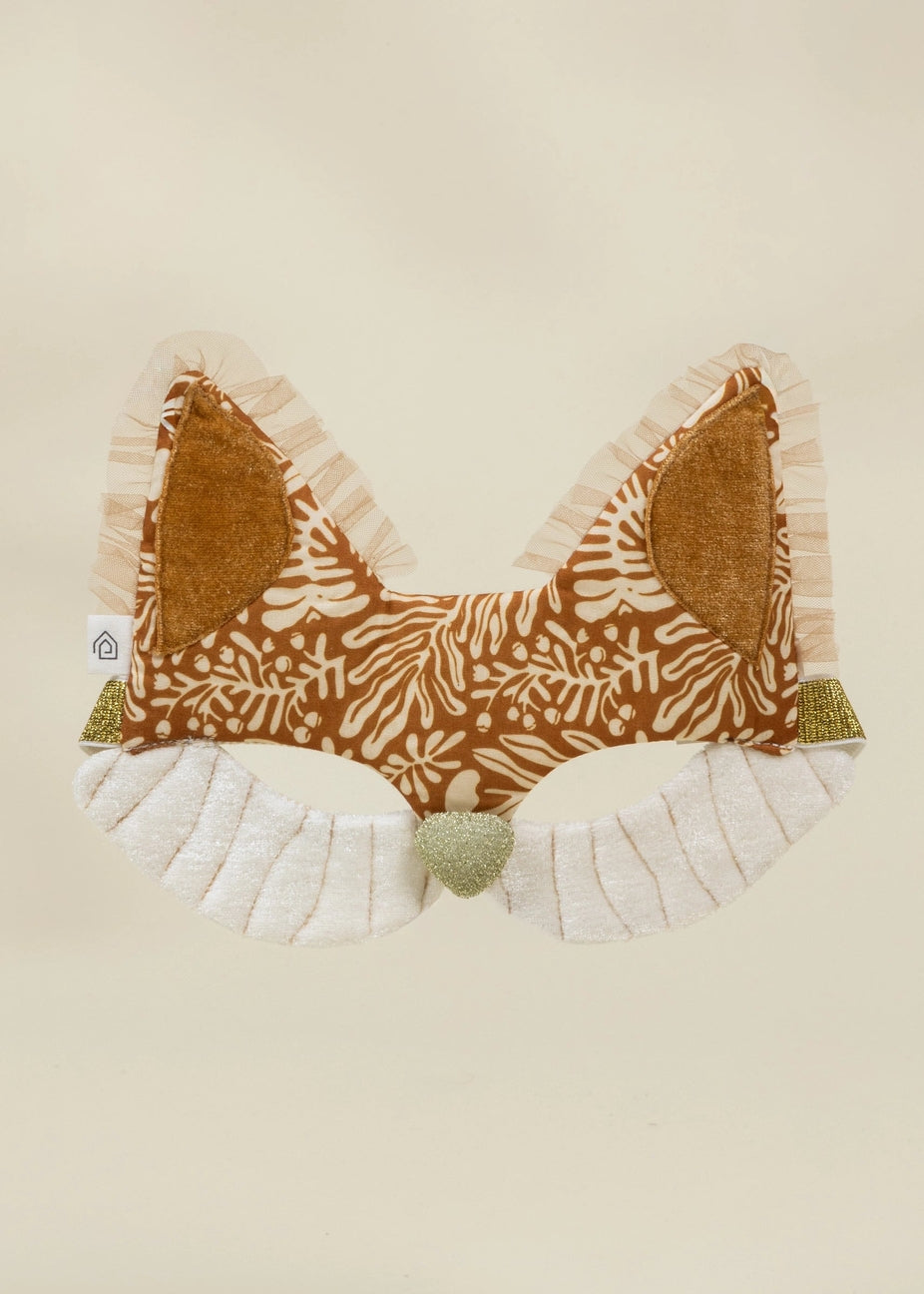 Fabric bow with brown pattern and white ruffles on a beige background