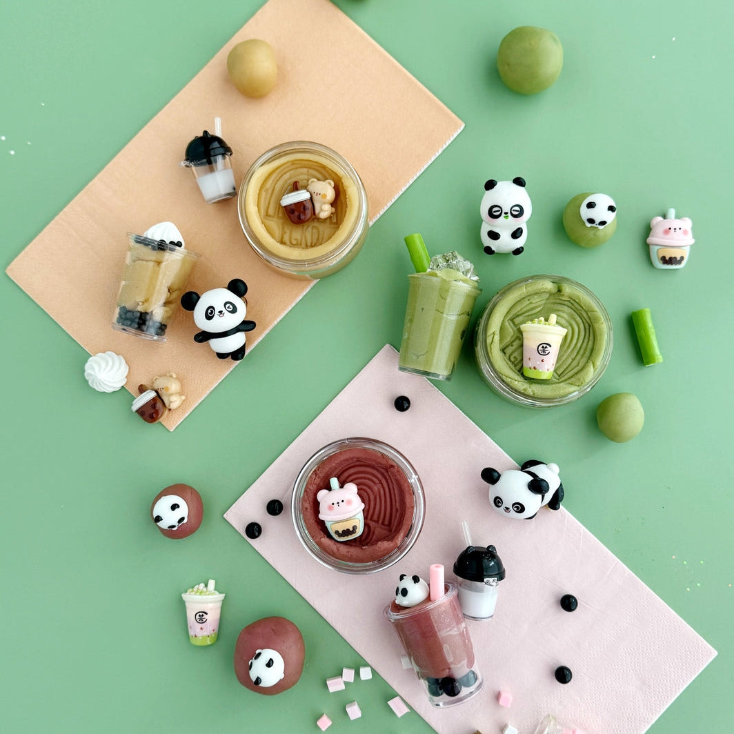 Various desserts and drinks with panda-themed decorations on a green background