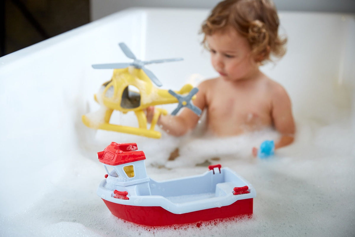 Child playing with toys in a bathtub filled with bubbles