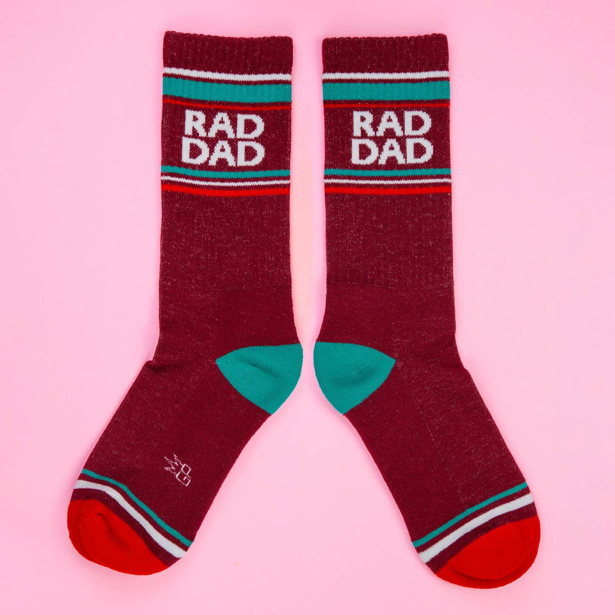 Maroon socks with 'BAD DAD' text on a pink background