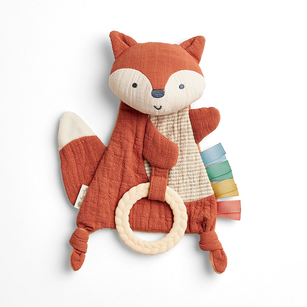 Stuffed fox toy with a ring on a white background