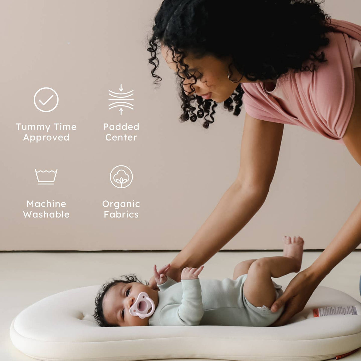 Woman with a baby on a cushion, with icons and text about product features.