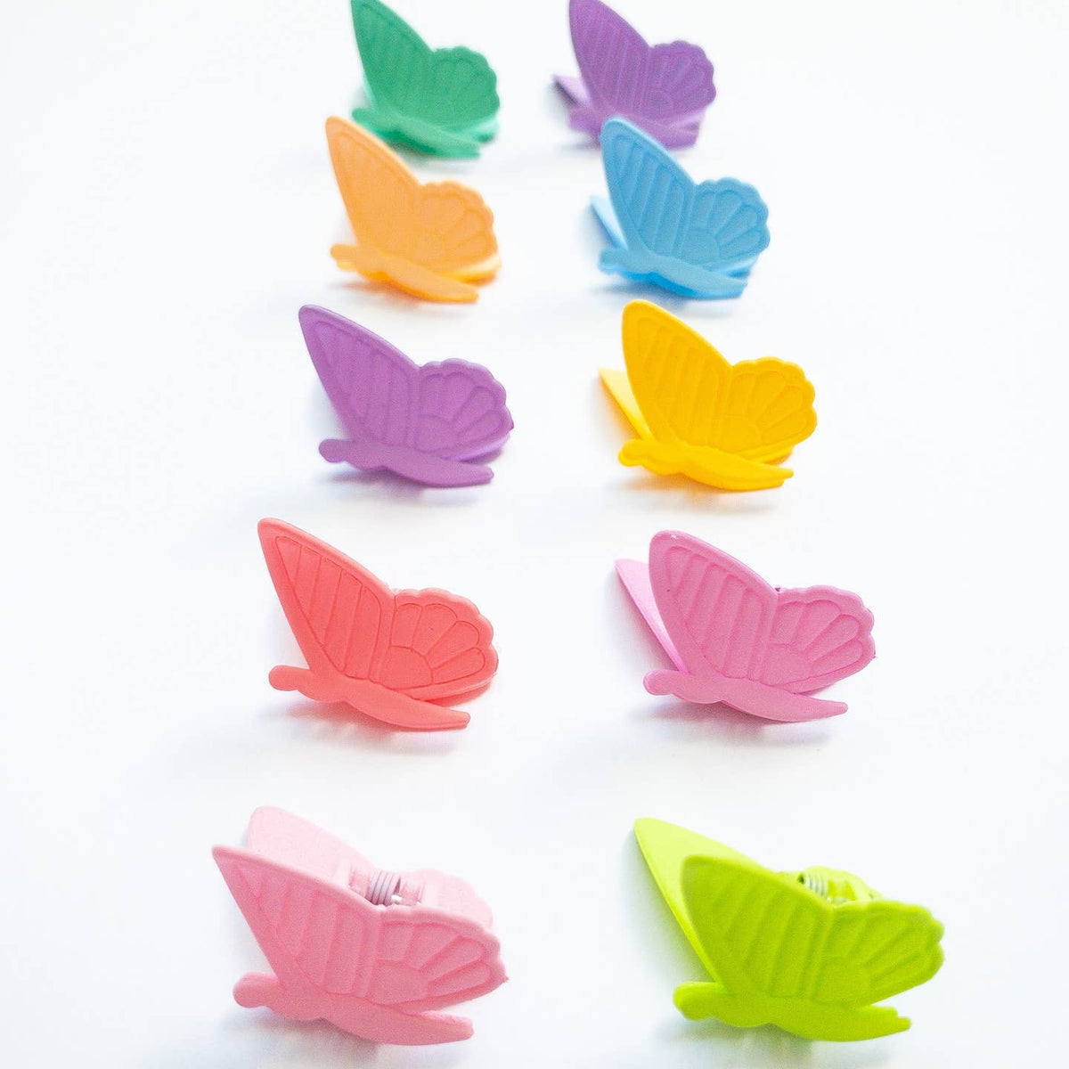 Colorful butterfly-shaped clips on a white background