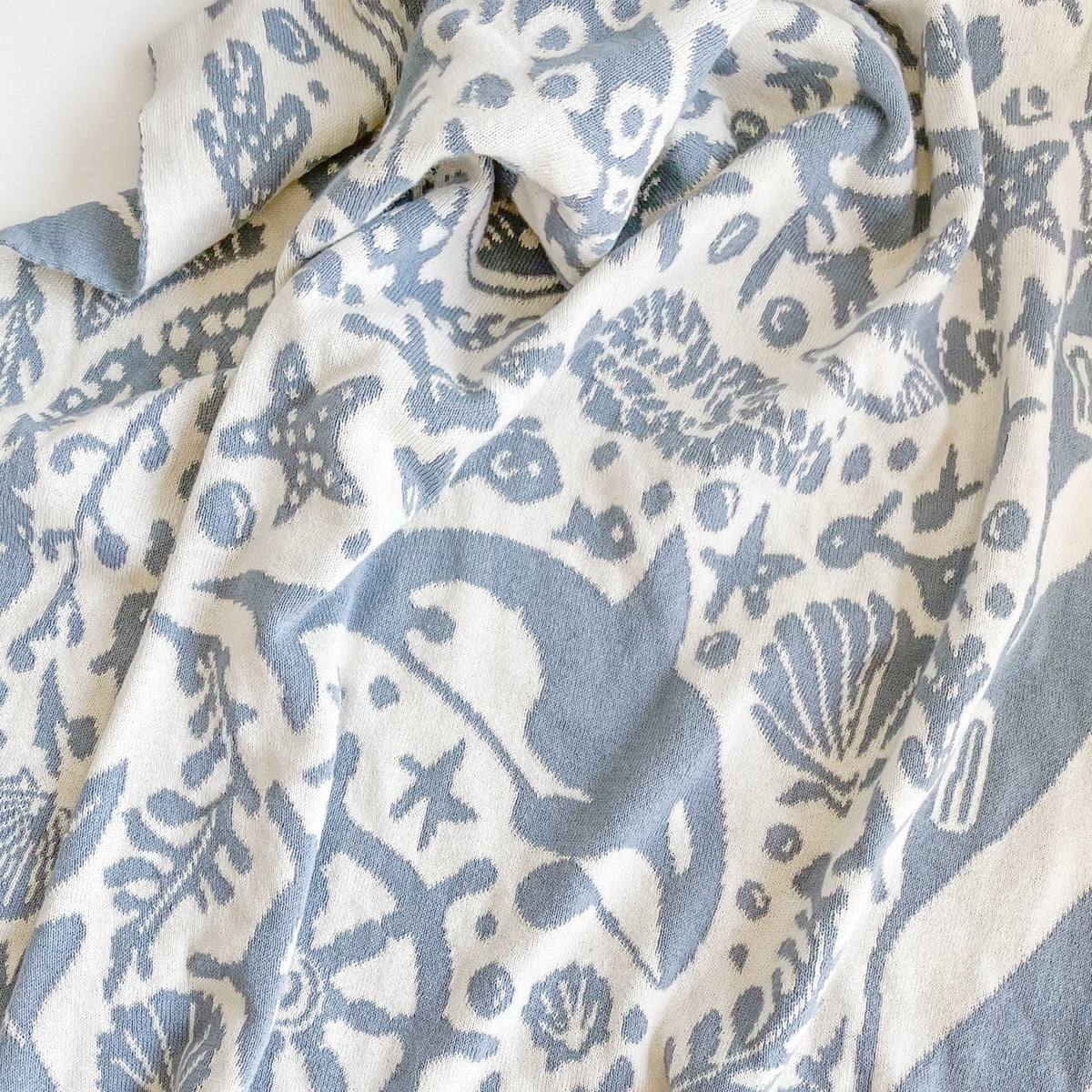 Close-up of a fabric with blue and white sea-themed pattern