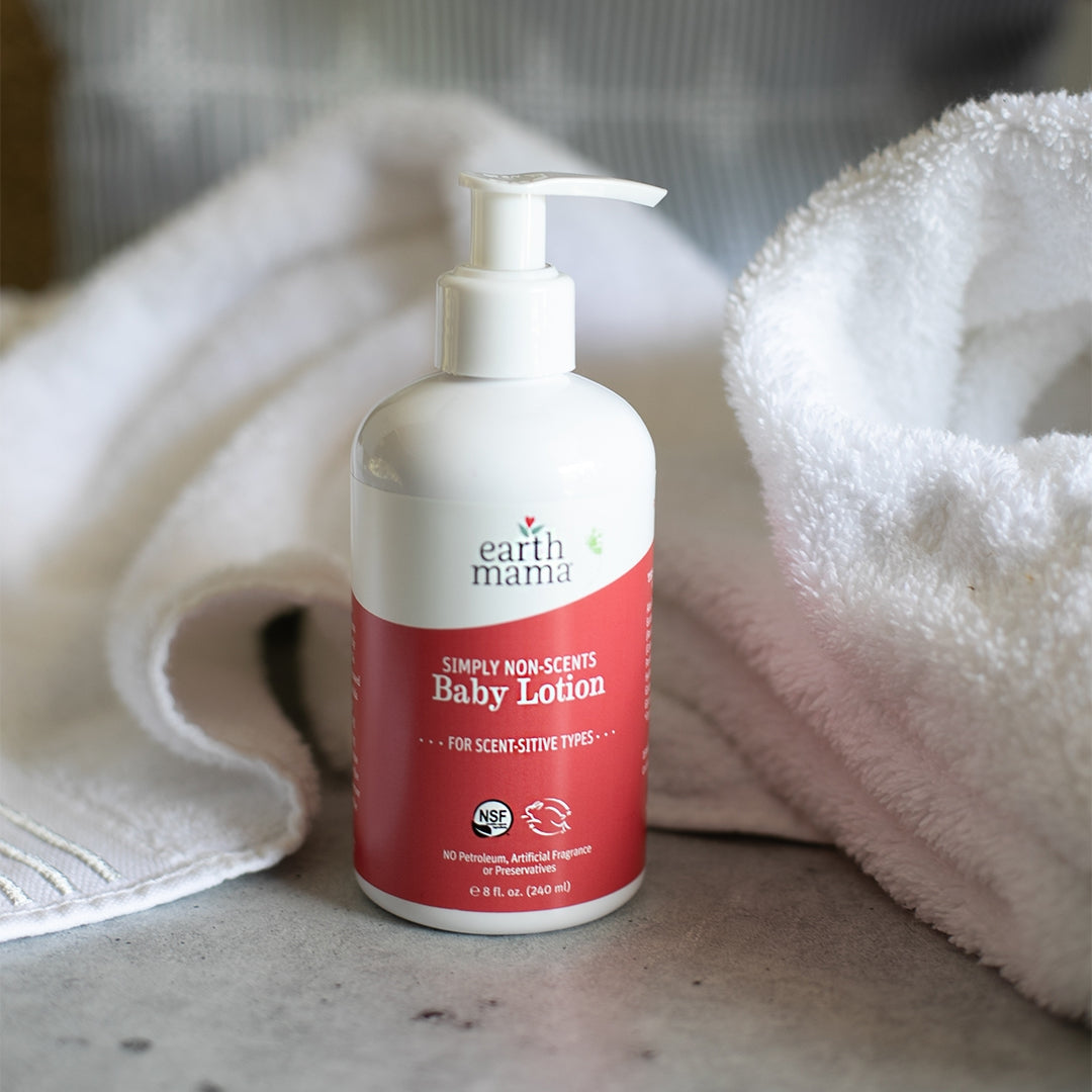 Earth Mama Simply Non-Scents Baby Lotion bottle with a white towel in the background