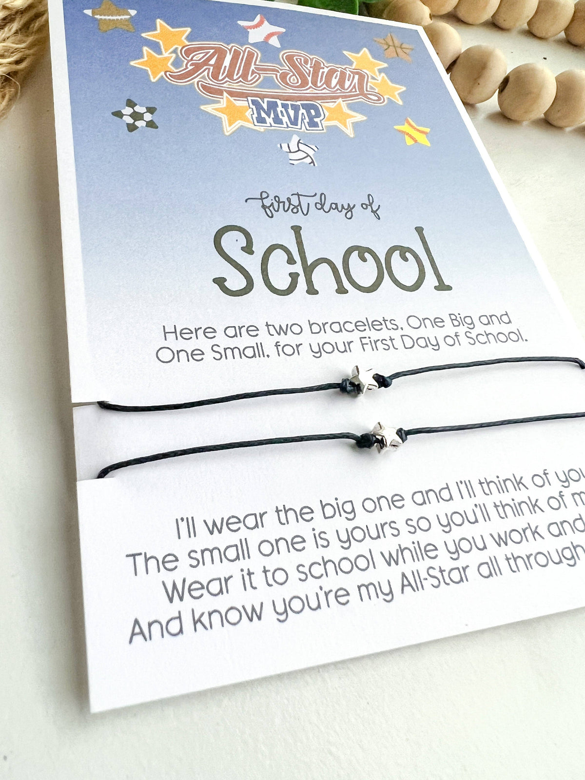 Two bracelets in a packaging with a message for the first day of school on a light background.