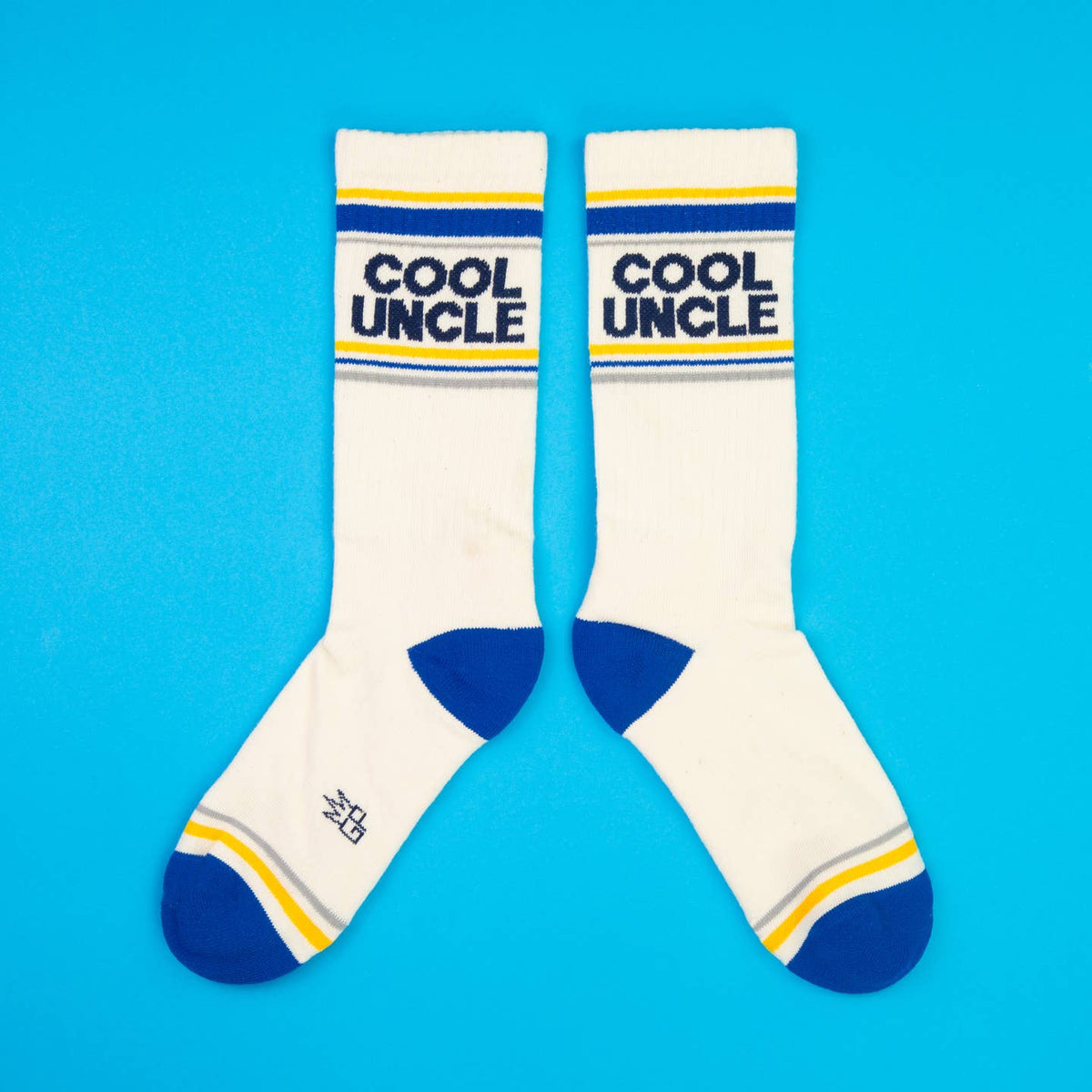 White socks with blue and yellow accents and 'Cool Uncle' text on a blue background