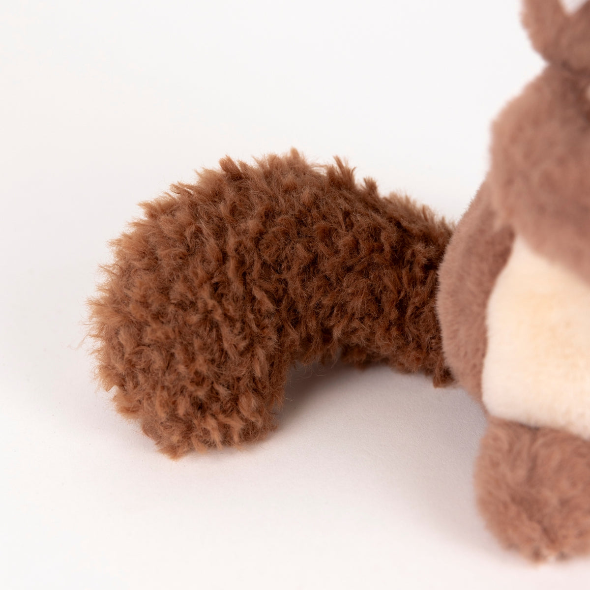 Close-up of a brown plush toy on a white background
