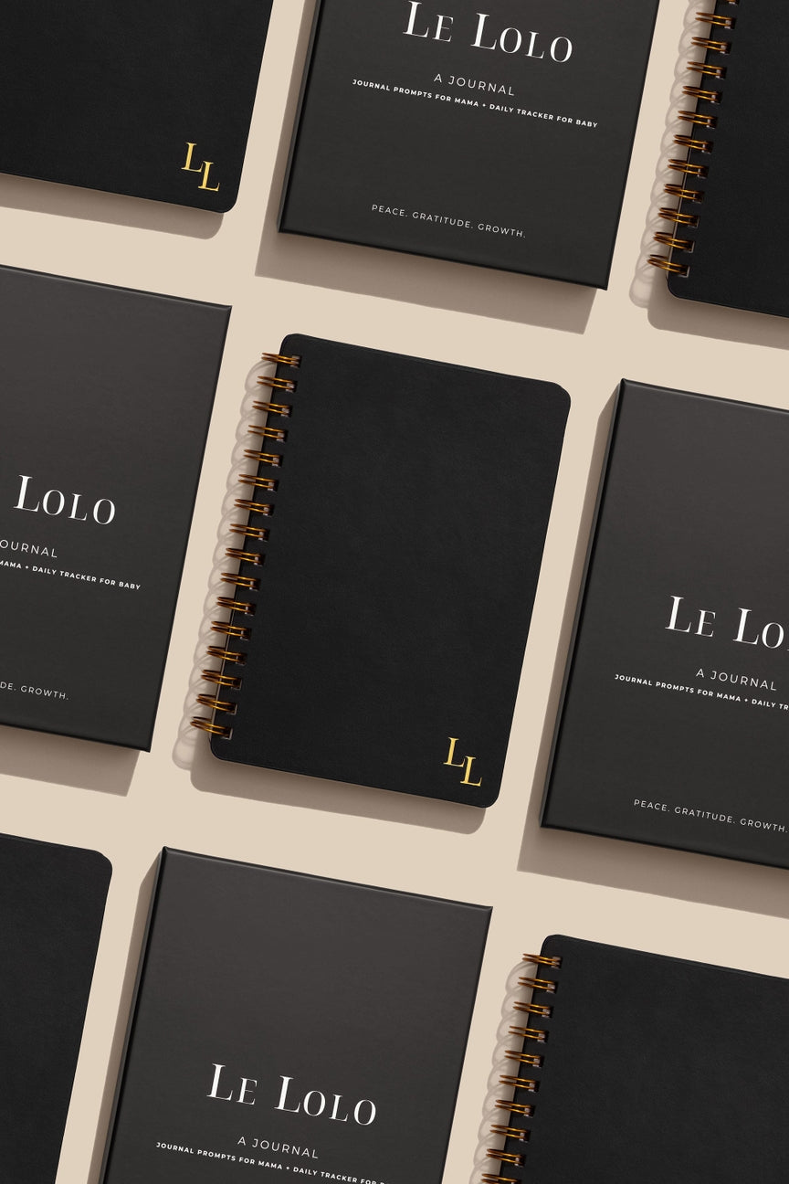Black journals with 'Le Lolo' branding on a light beige background