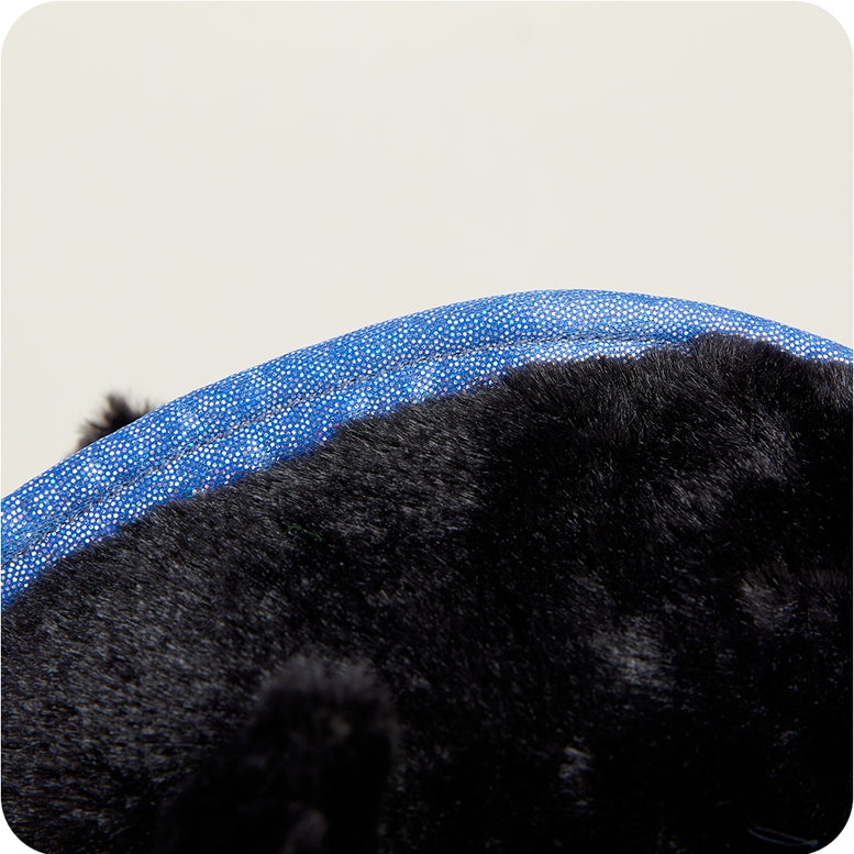 A close-up view of the top of a black and blue Axolotl Junior plush toy by Warmies, showcasing its soft black fur and vibrant blue frilly external gills.