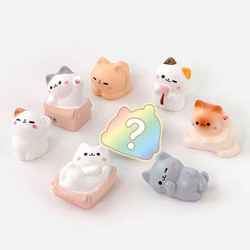 Set of cute cat-shaped desk toys with a colorful question mark icon on a white background