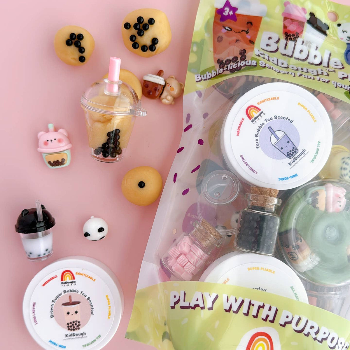 Collection of bubble tea-themed squishies and packaging on a pink background