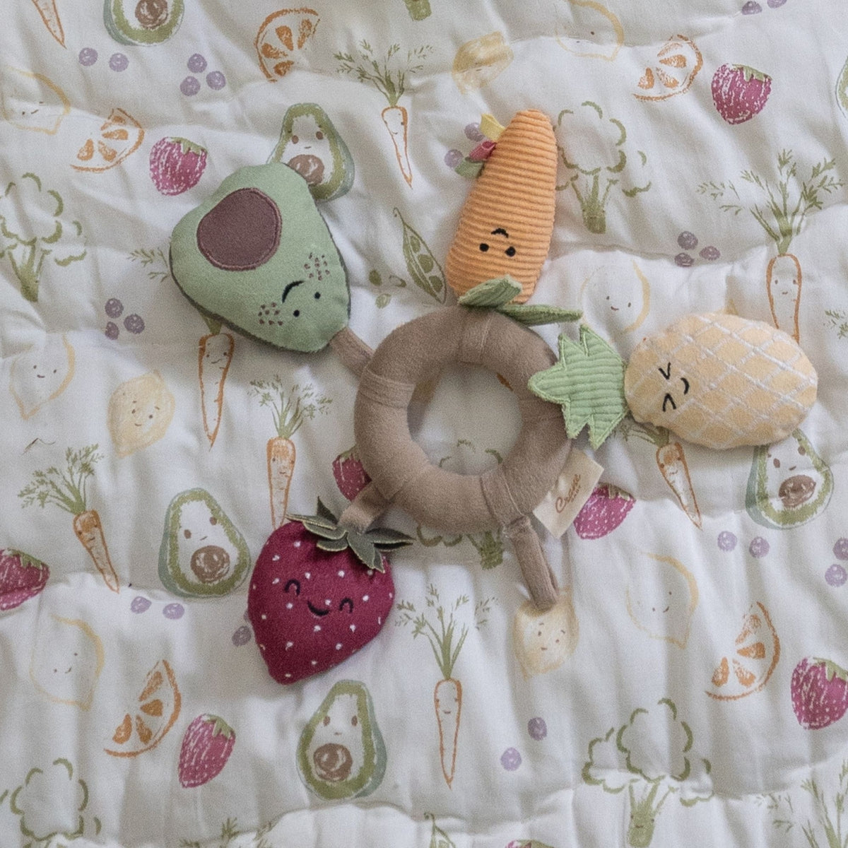 Set of soft toy vegetables on a patterned blanket