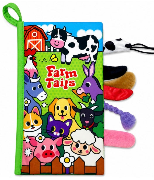 A children's fabric book or toy titled 'Farm Tails' with a colorful cartoon farm illustration on the front cover, a green hanging loop, and several plush fabric tails in black, white, brown, red, purple, and pink extending from the side, shown on a white background.