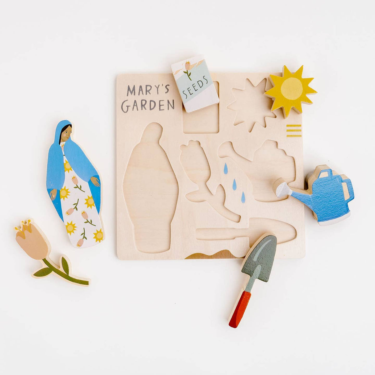Wooden puzzle set with religious figures and gardening elements on a white background