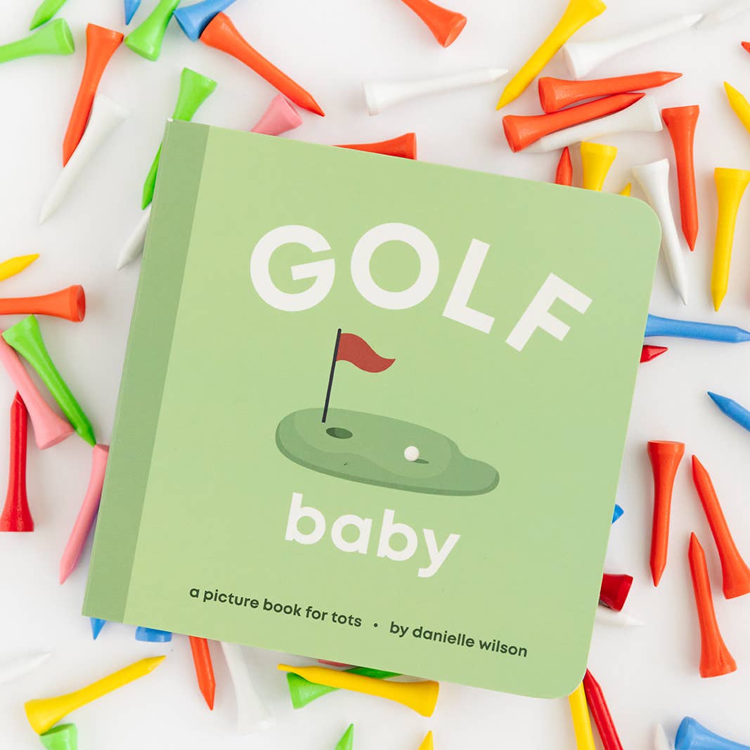 Children's book titled 'Golf Baby' surrounded by colorful golf tees on a white background
