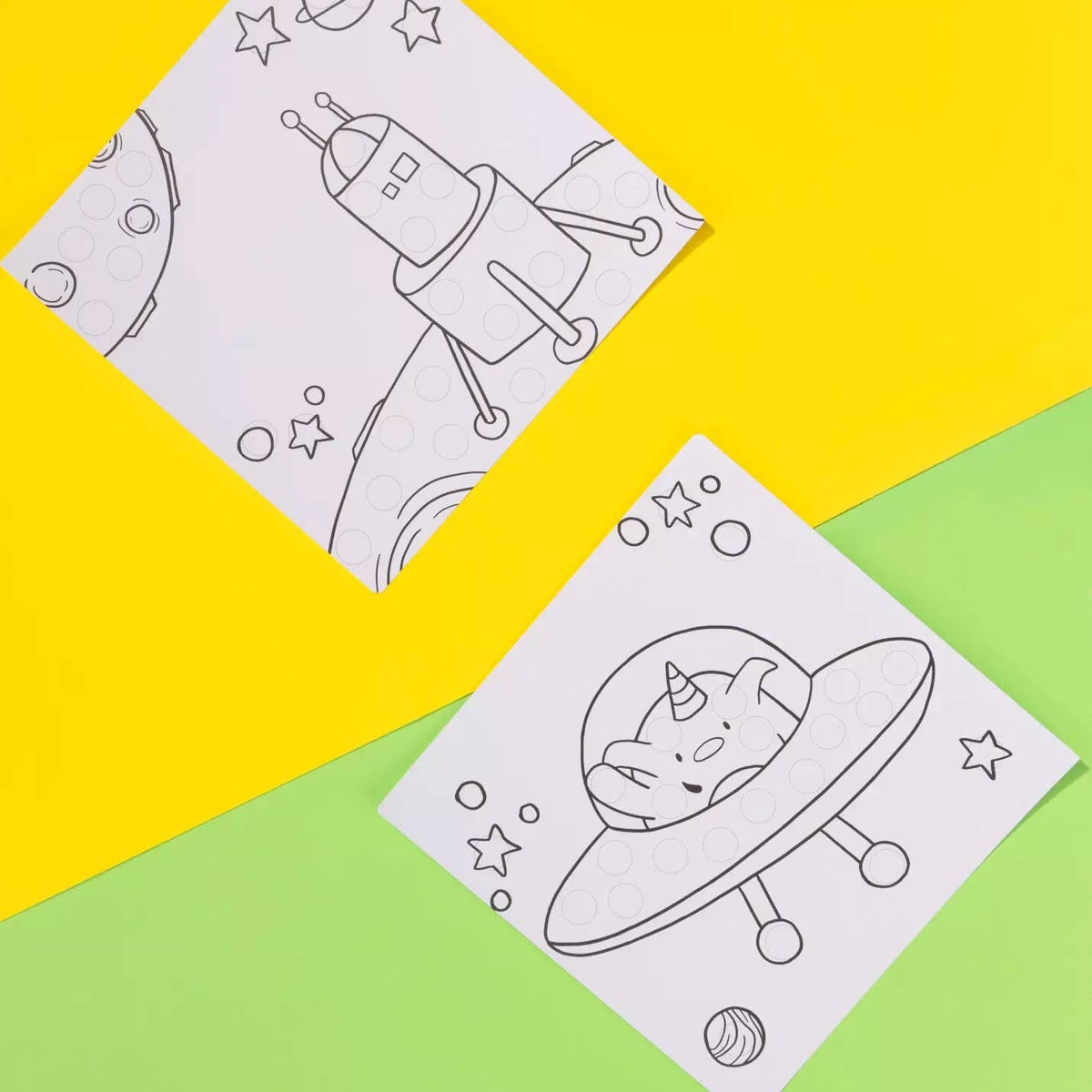 Two coloring sheets with space-themed designs on a yellow and green background