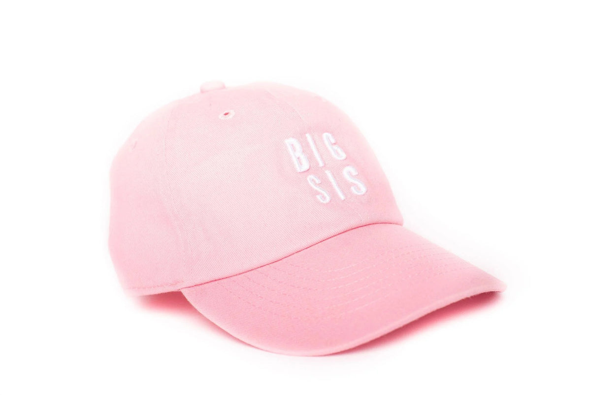 Pink cap with 'BIG SIS' text on a white background