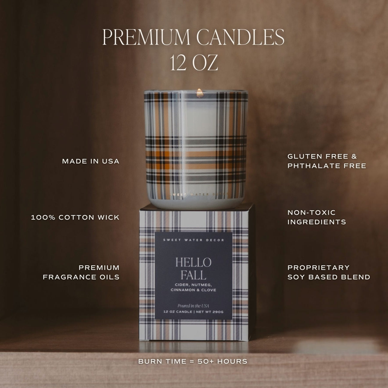 A lit 12 oz premium candle in a plaid-patterned glass jar sits on top of its matching box. The candle packaging and jar feature a brown, beige, and black plaid design, with white text overlays highlighting product features such as 'PREMIUM CANDLES 12 OZ', 'MADE IN USA', and 'HELLO FALL'.