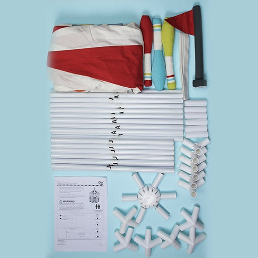 Unboxed Kids Deluxe Circus Tent Playhouse laid out with all its assembly parts, including white plastic support poles, connector joints, a red-and-white striped fabric tent cover, a small red flag, and an instruction manual.