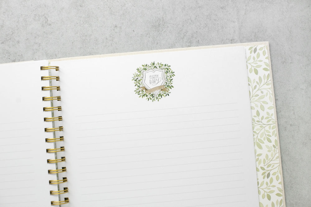 White planner with gold binding on a gray surface