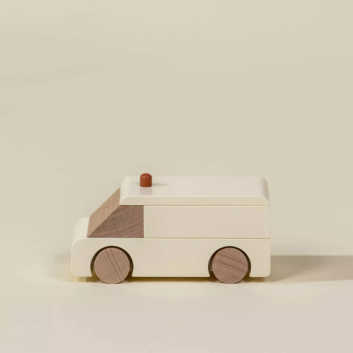 Wooden toy car on a beige background