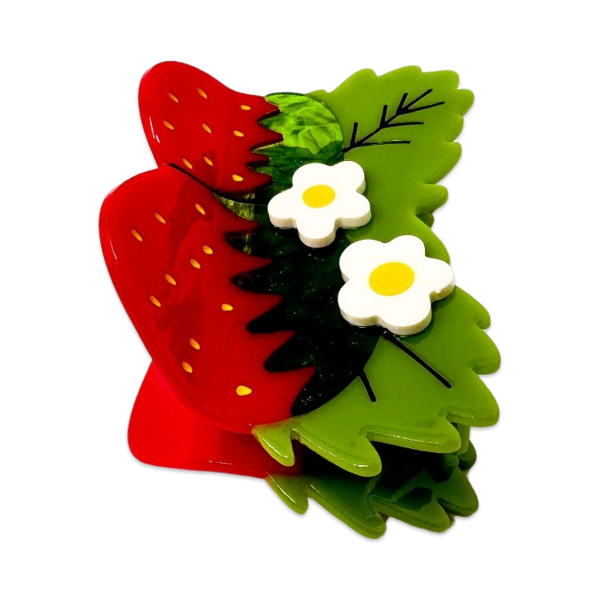 Red strawberry-shaped object with green leaves and white flowers on a white background