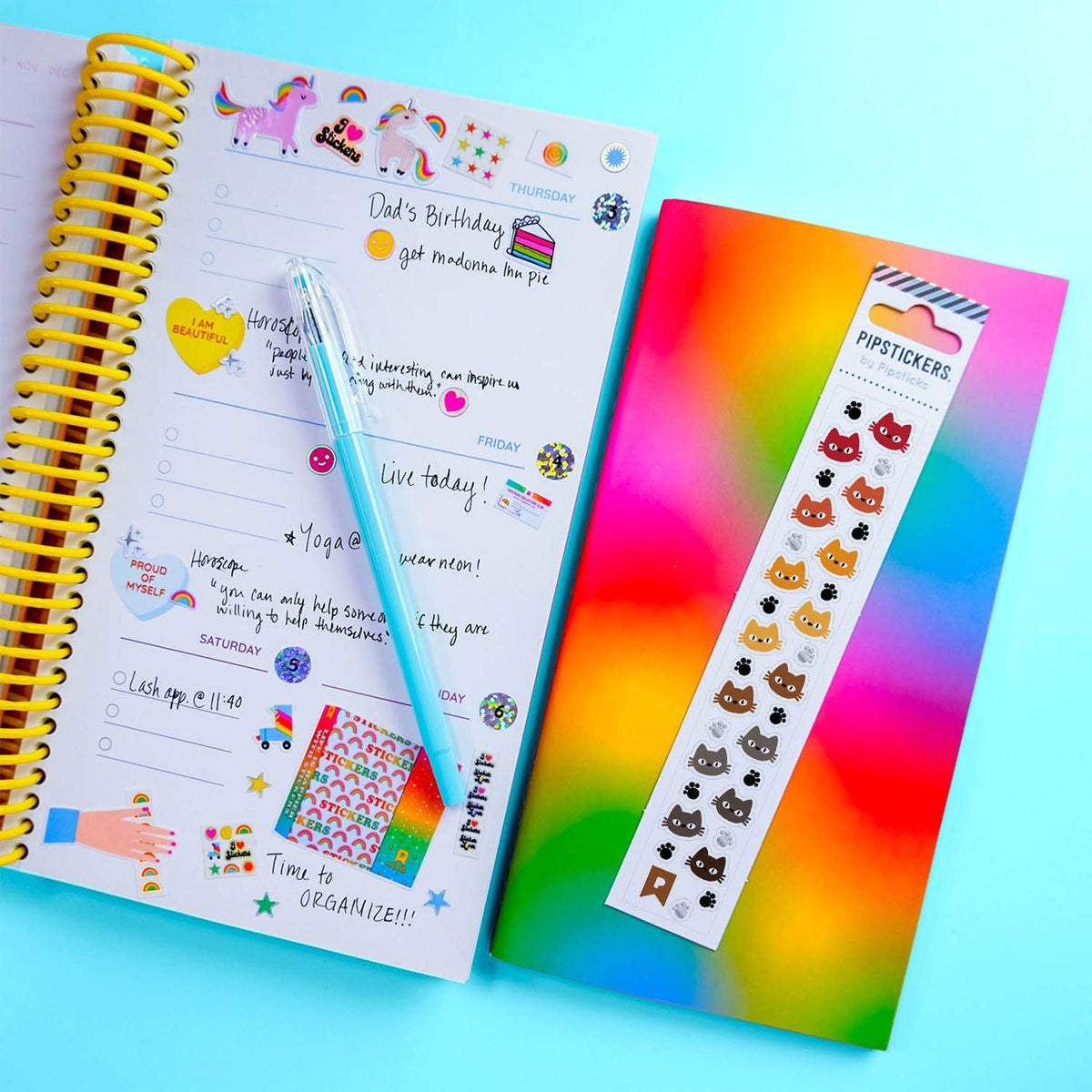 Notebook with colorful stickers and pen on a bright background