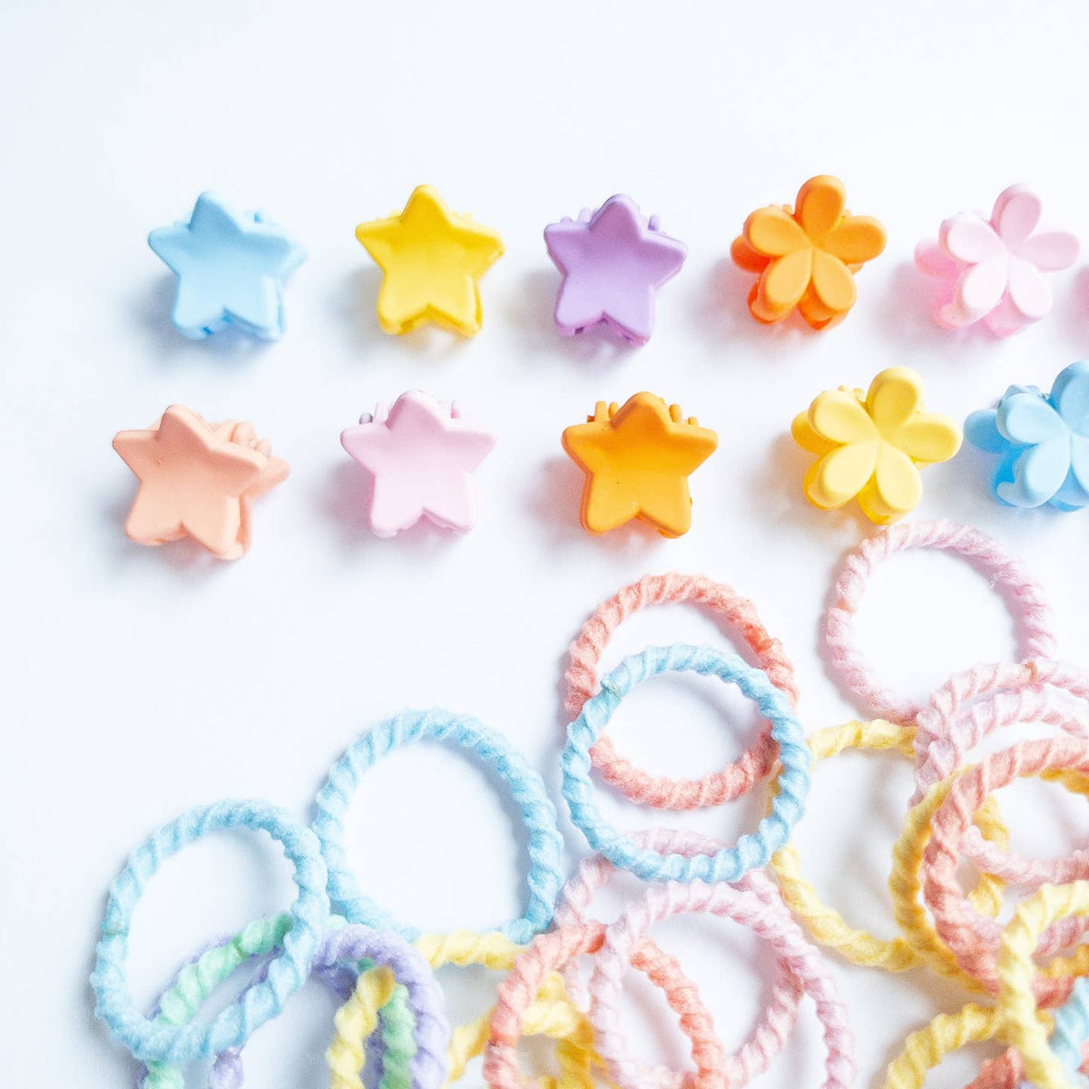 Pastel-colored star-shaped hair ties on a white background
