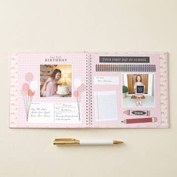 Open planner with photos and text on a light beige background